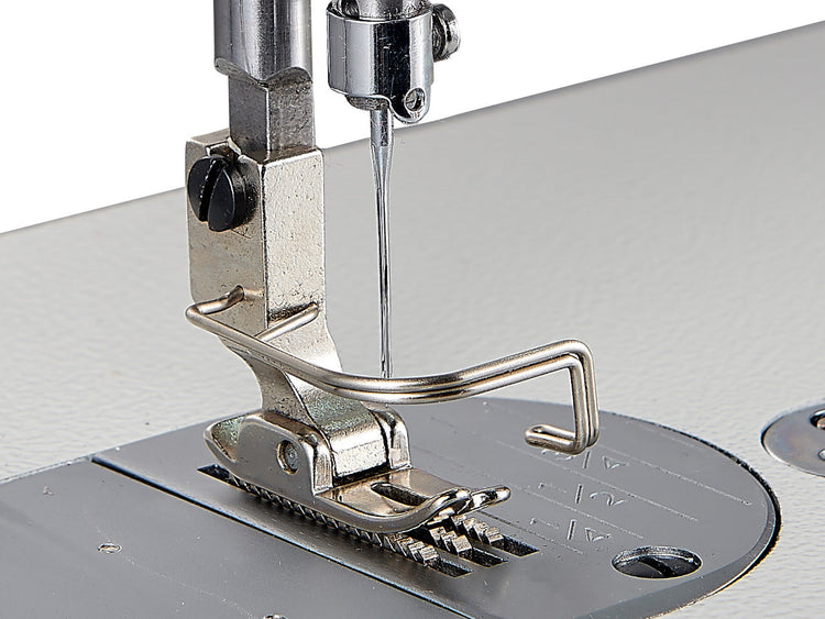A close up of a Singer sewing machine foot and needle without thread
