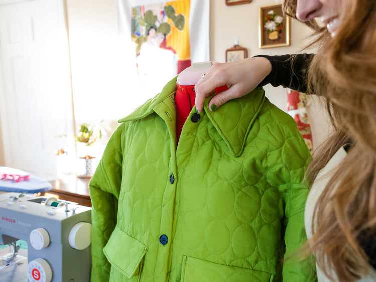 A Singer dress form with a green jacket