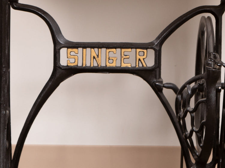 A cast iron vintage Singer sewing machines logo
