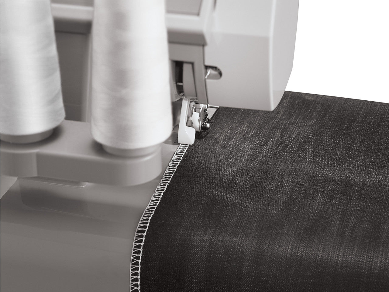 White stitching being shown on a piece of black heavy duty fabric using a SINGER heavy duty overlocker