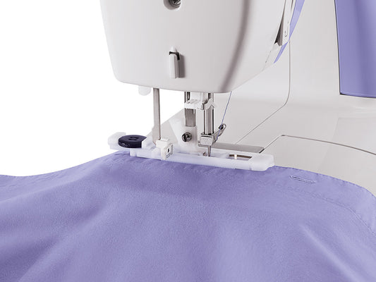 Close up of a buttonhole being stitched on a mauve shirt using a SINGER Simple 3232 sewing machine