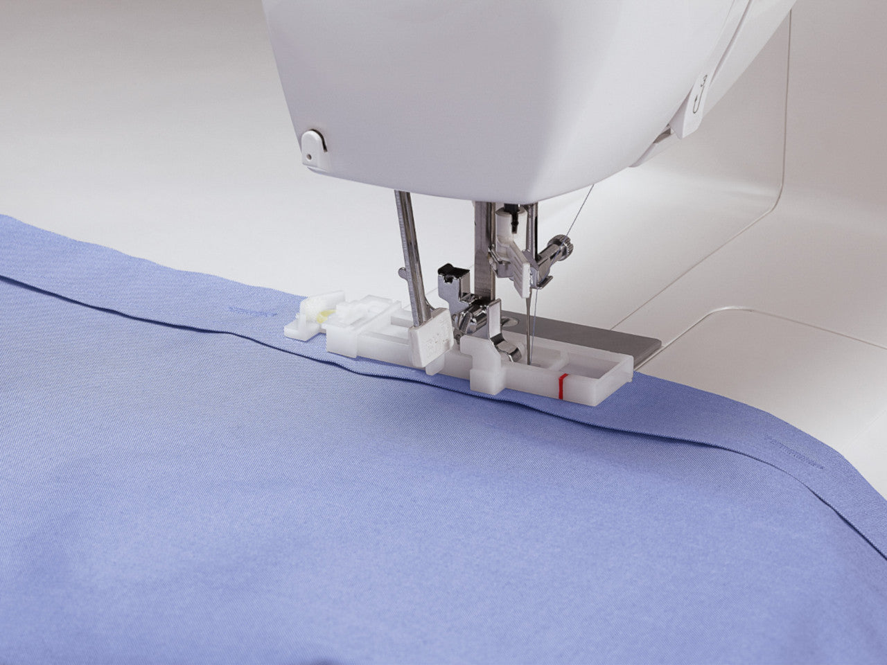 Buttonhole stitching on a mauve shirt using a SINGER sewing machine