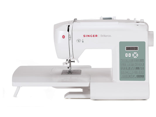 A white Singer Brilliance 6199 electronic sewing machine with a digital display and an extension table.