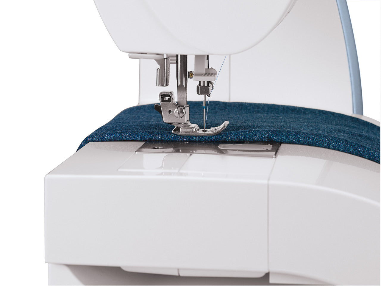 Close up of blue denim fabric being stitched ousing a SINGER Quantum Stylist 9985 sewing machine