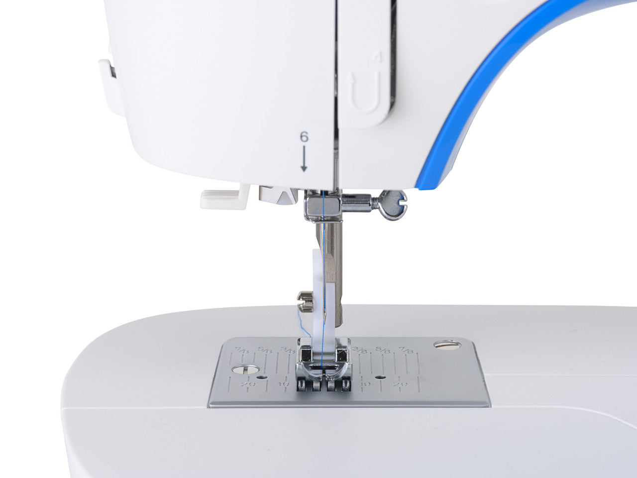 Close up of a needle plate on a white SINGER M3205 sewing machine with blue accent.