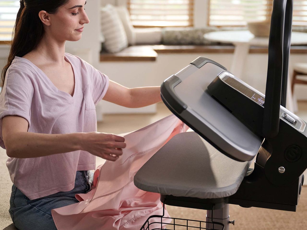 lady-using-the-esp36-steam-press-stand-folding-a-shirt