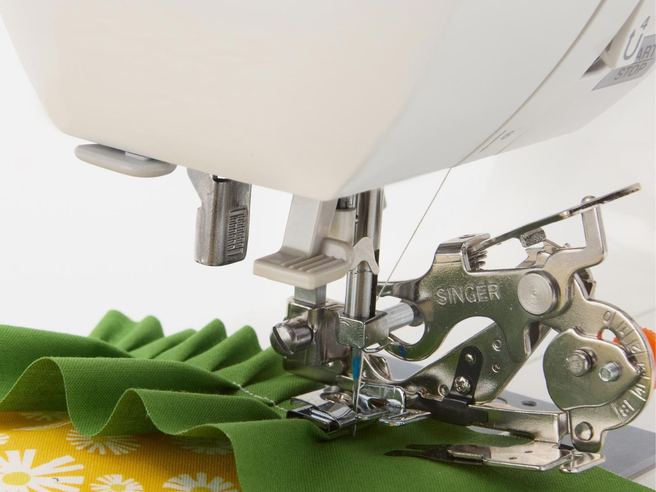 singer-ruffler-foot-on-singer-machine-creating-ruffles-on-green-fabric